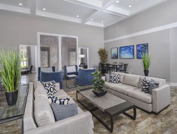 a living room with couches and chairs and a table at The Residences at Springfield Station, Springfield, Virginia